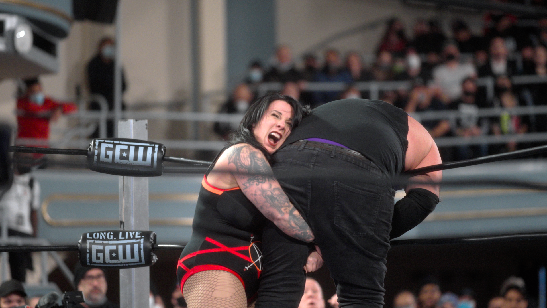 The Selling Stage — Lufisto silhouetted in red ring lighting before walking out to the crowd